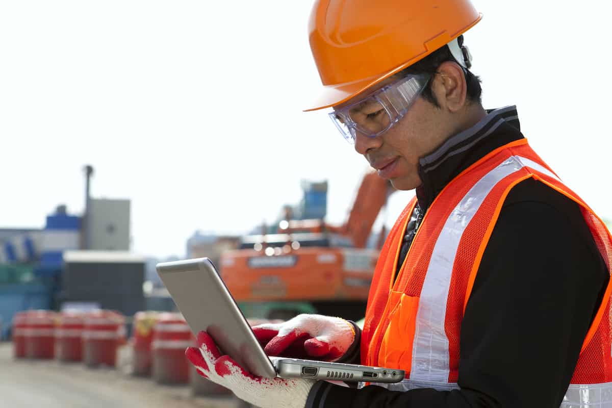 Contractor on a device at a site