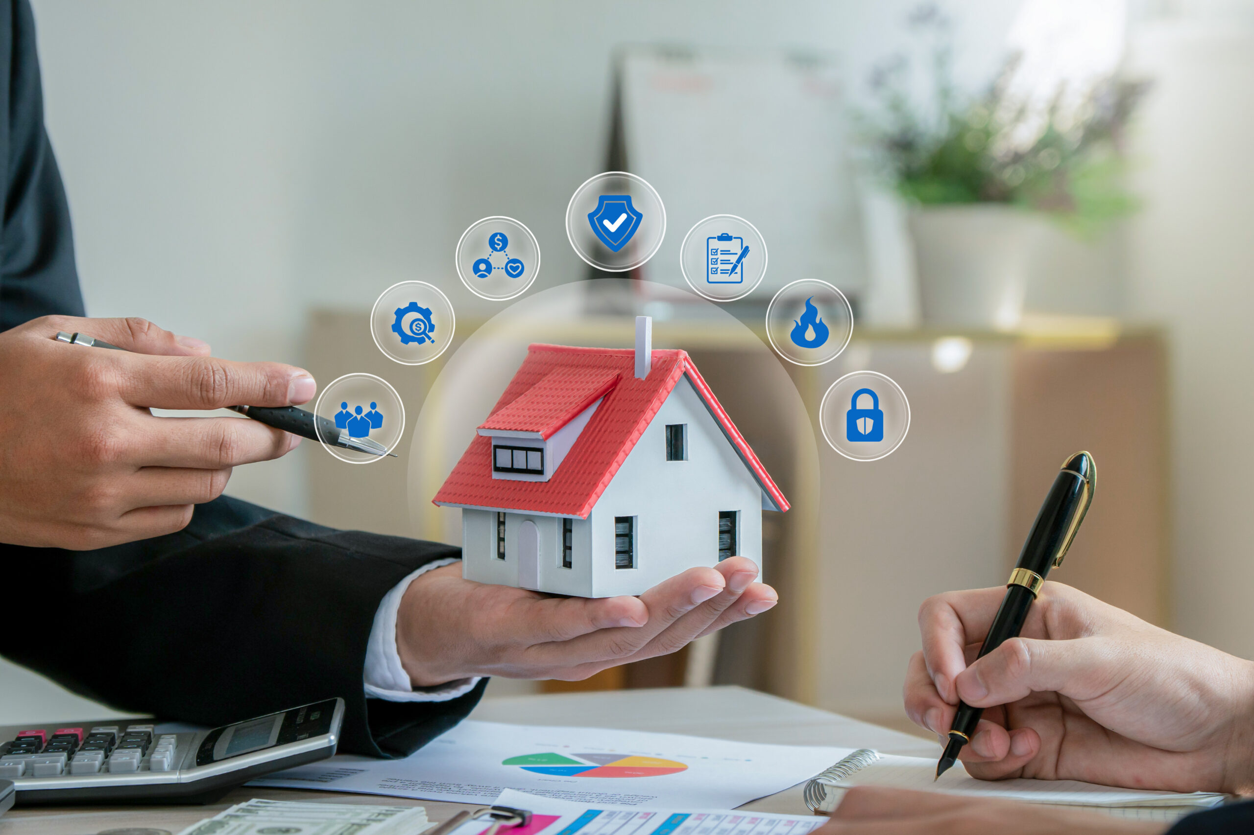 MCS-Phoenix-home-remodel-General-Contractor-sm2 Close-up of a miniature house with a red roof held in a person's hand during a real estate consultation. Surrounding the home are icons representing property protection, security, insurance, compliance.