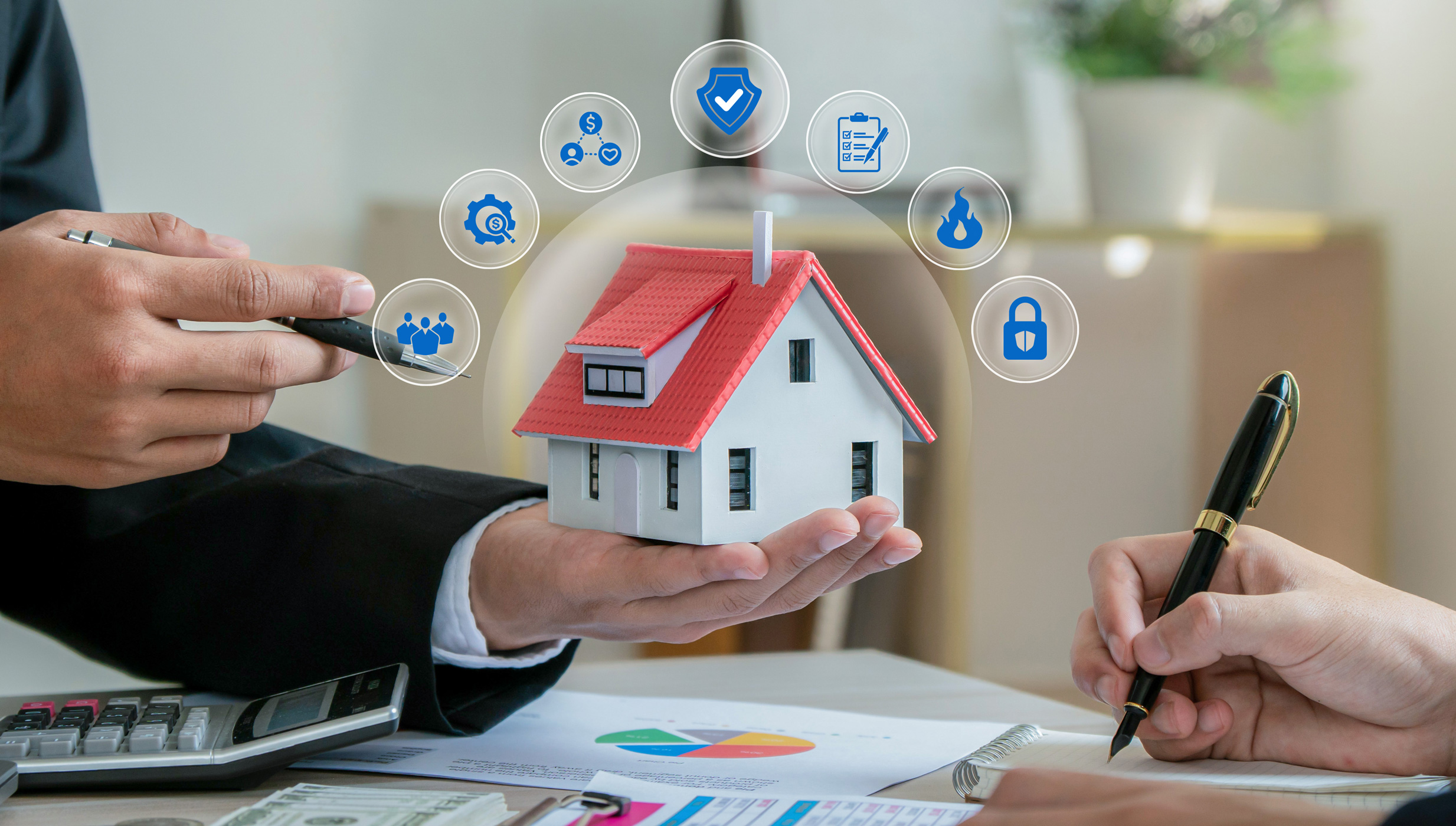 Close-up of a miniature house with a red roof held in a person's hand during a real estate consultation. Surrounding the home are icons representing property protection, security, insurance, compliance.
